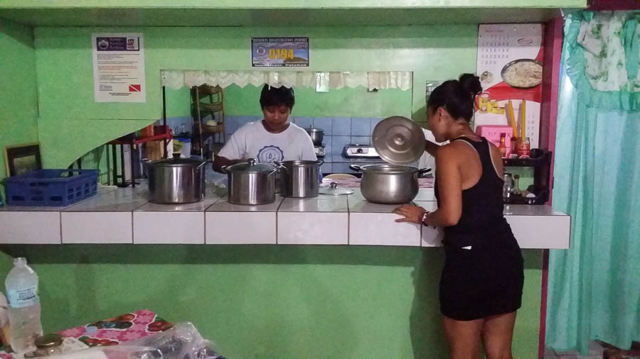 Irene mira hoyas en restaurante Cagayan, Port Barton, Filipinas